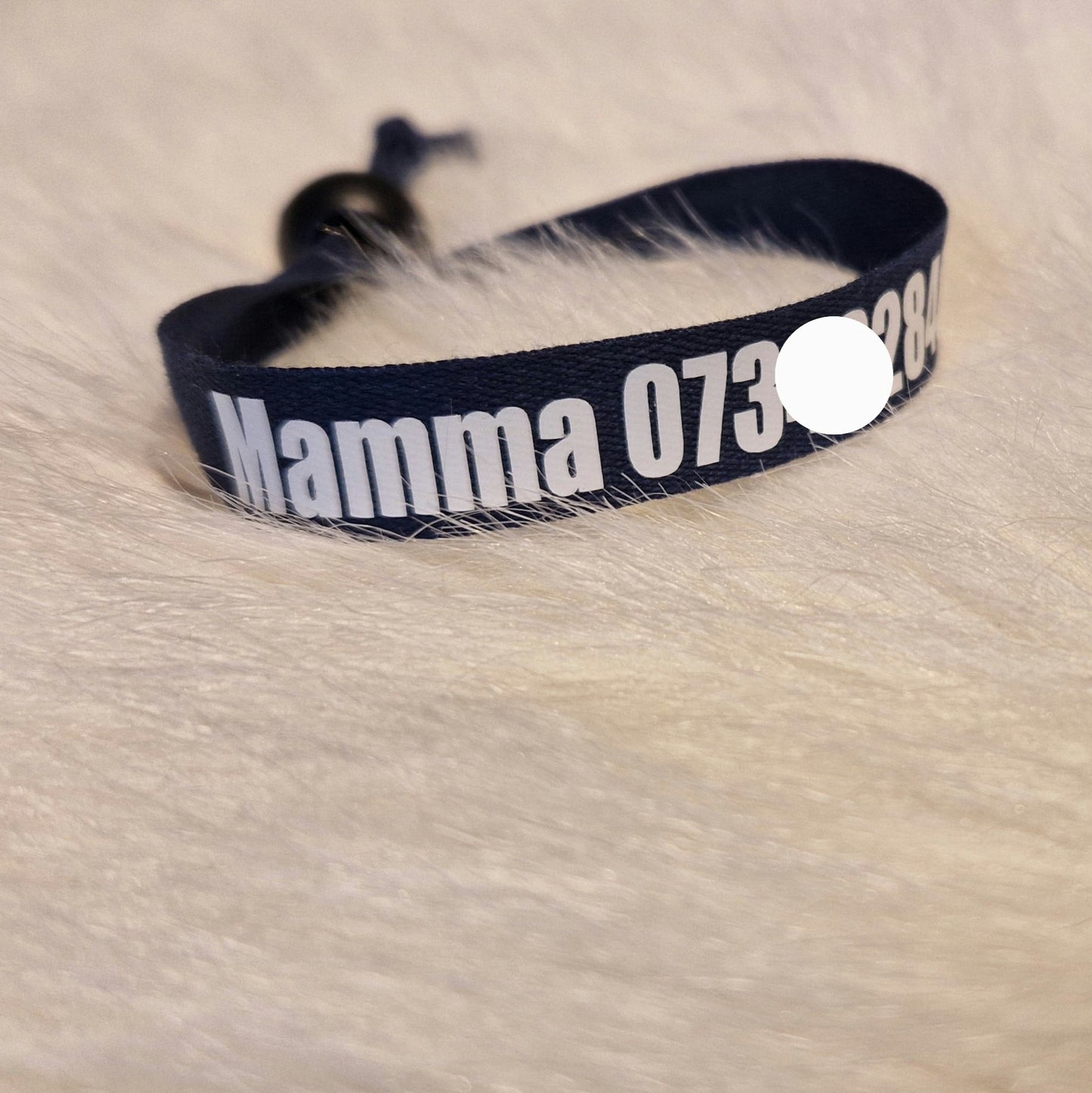 Barn bär id-armband med namn och telefonnummer