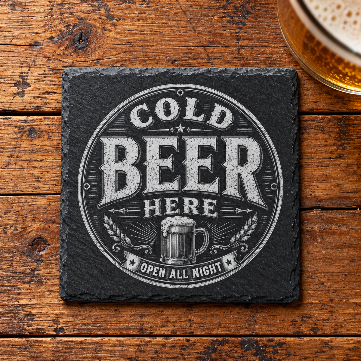 Glasunderlägg i skiffer med graverad ölsejdel och texten Cold Beer Here – Open All Night i en rund vintageram.