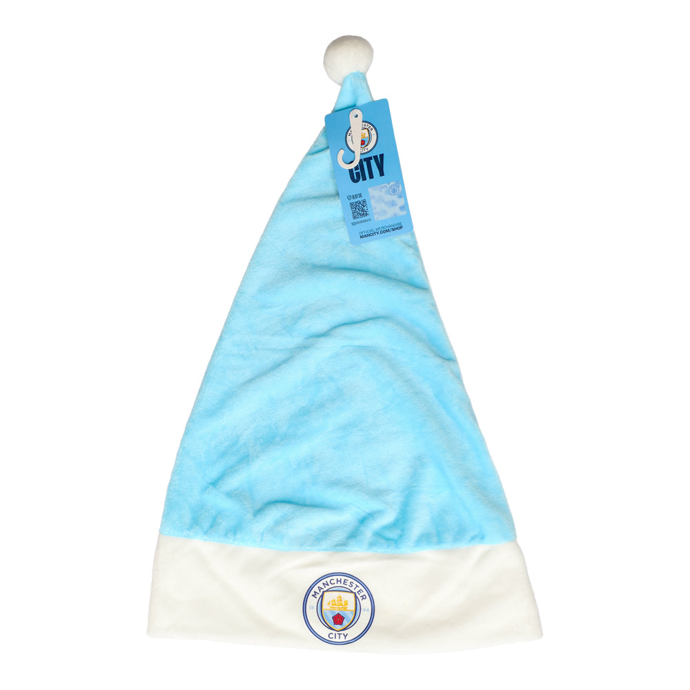En ljusblå tomteluva med vit kant och boll, prydd med Manchester City FC:s klubbmärke.